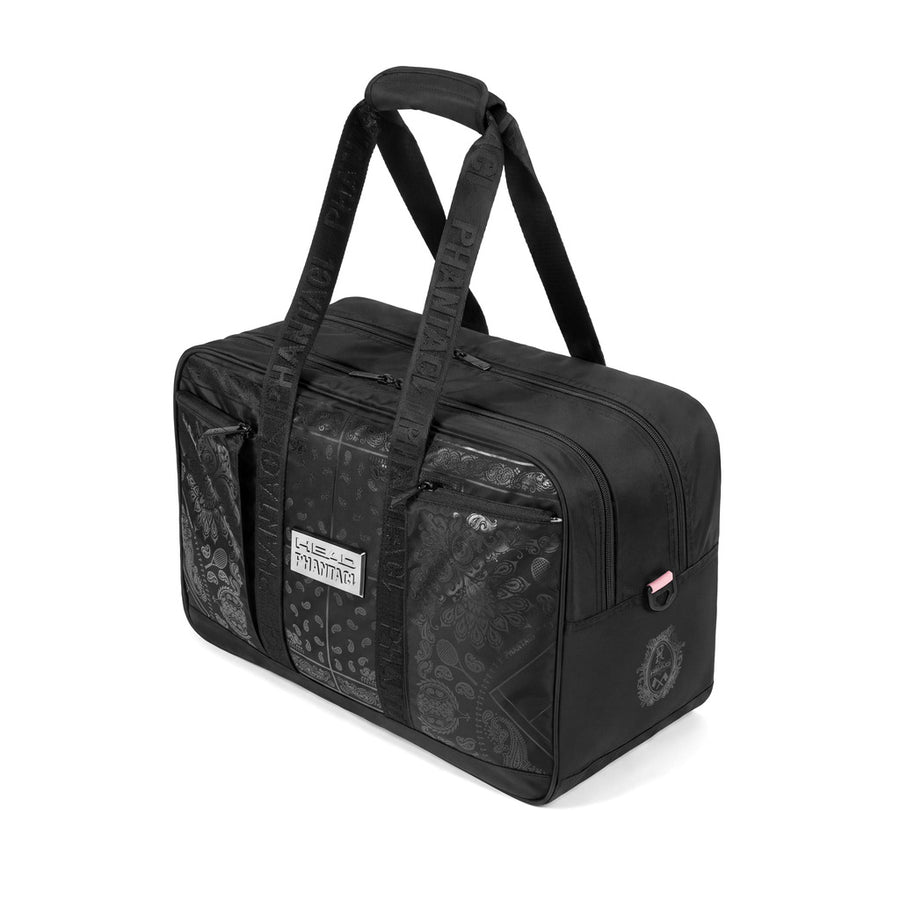 A black duffel bag with a subtle gothic skull and crossbones pattern, featuring dual top handles, a front zippered pocket.