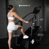 Woman using a Stepr Go step machine with features highlighted on a dark brick wall background.