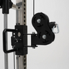 Black pulley system attached to a metal frame on a white background